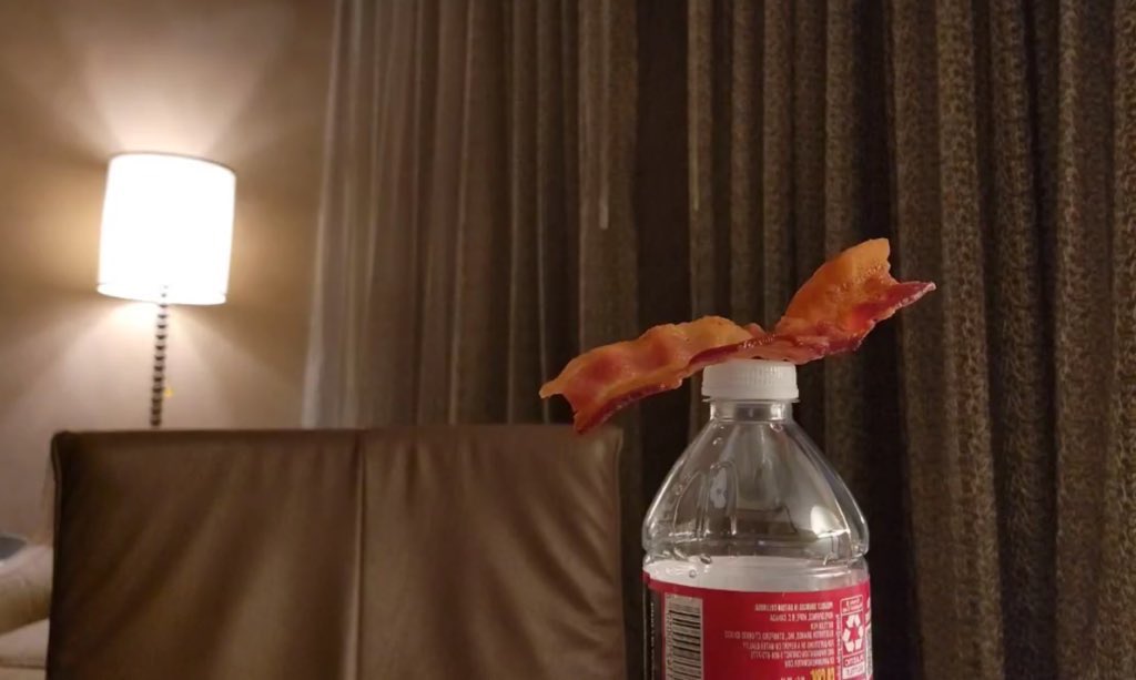 translatingTXT's tweet photo. beomgyu set up his bacon on the water bottle so we have something to look at while he goes and makes his ramen 😭 https://t.co/omPnY9yAw6