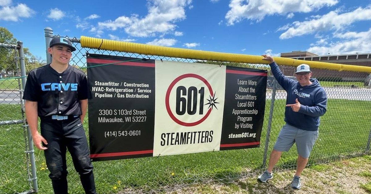 Steam601's tweet photo. Steamfitters Local 601 is proud to have a sponsorship banner on the outfield fence at St. Thomas More High School! Pictured are Local 601 member Steve Schmidt and his son Gabe, who plays for the St. Thomas More Varsity Baseball team. #Local601 #UnionStrong #Steamfitters https://t.co/IeC539yQIM