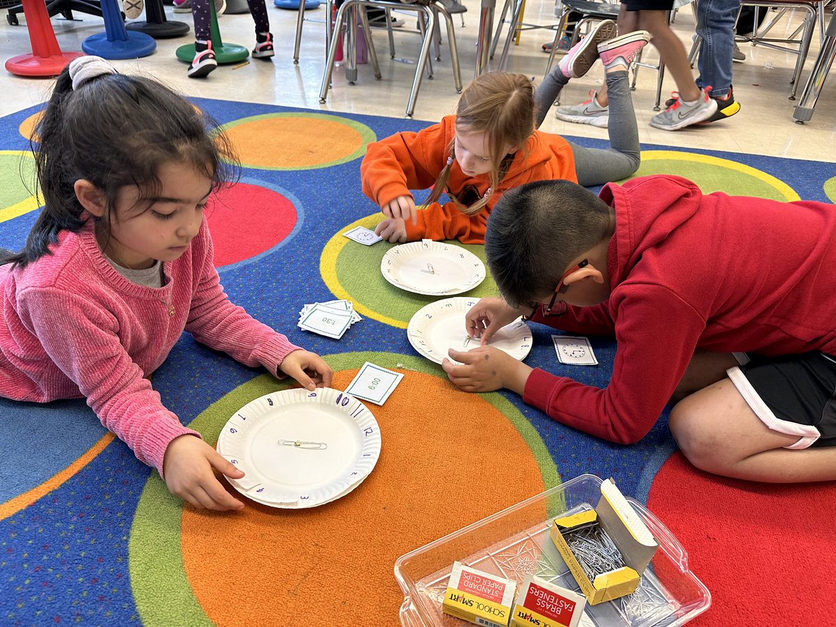 Pre-teaching telling time to the nearest 5 minutes in centers! We created our own clocks to practice ⏰ #EWLearns