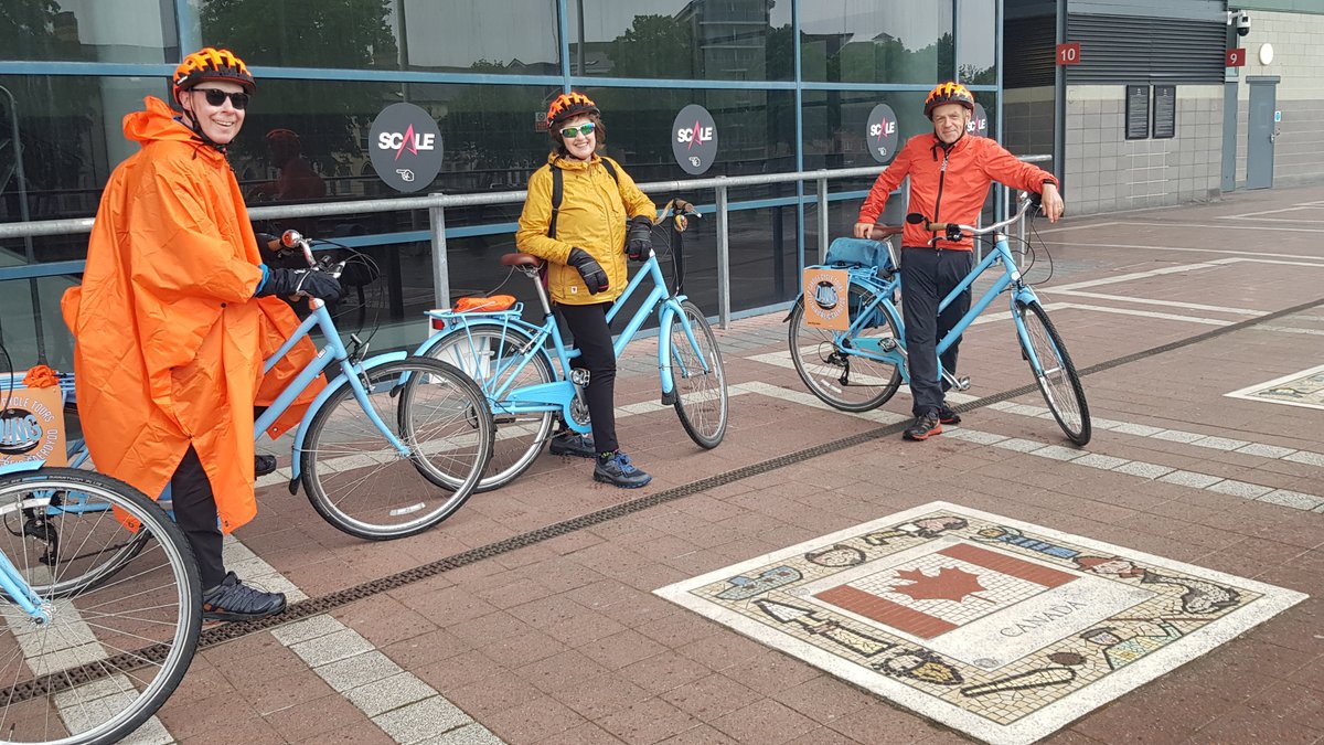 DingCycleTours's tweet photo. Stopped off for a bit of shelter and a photo opportunity by the Canadian flag outside the @principalitysta with our visitors from Newfoundland.  Apparently it rains there too! ☔️🇨🇦🚲
@FOR_Cardiff @ILovesTheDiff @itsoncardiff https://t.co/ADqXAS6t4g