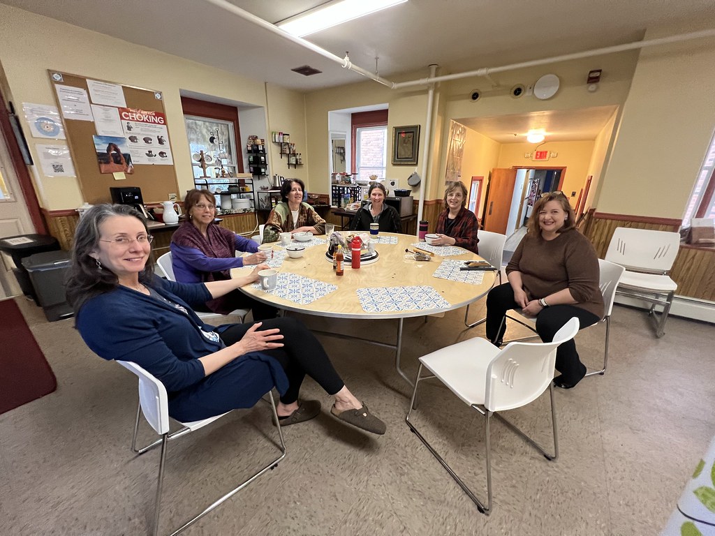Writers relax around the table after a day working hard on their writing projects.