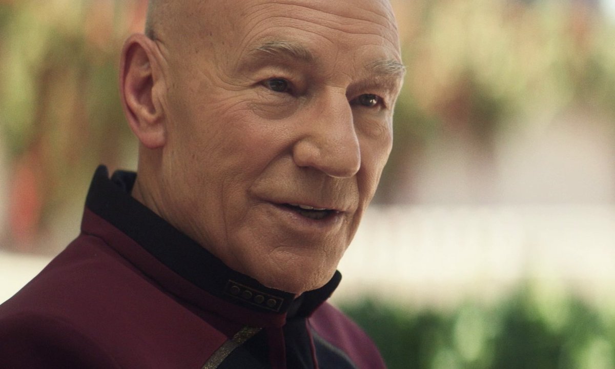 Hours later… Picard dips his head into a sterile white and gray room. Outside, winds howl. Romulan refugees chatter. Laughter springs from playing children. “Hello,” Picard says. “I hope I’m not intruding.” An older Romulan woman sits on a white thin bed. 4/9