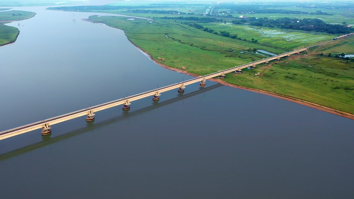 A two-tone symphony of land and water coalesces with a Rail bridge stretching across the Mahanadi River in Odisha.