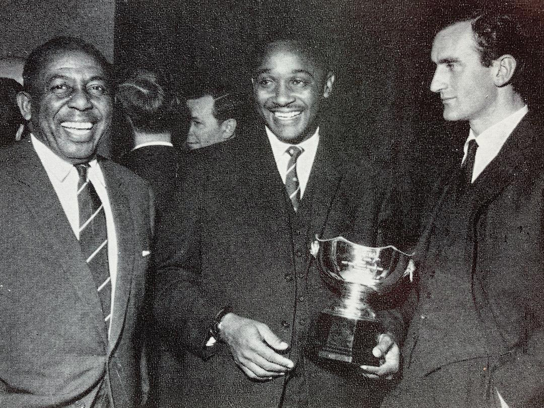 The facial expressions suggest West Indies have won it, and the fact that this snap is of Learie Constantine, Frank Worrell and Ted Dexter suggests it's 1963, but that isn't the Wisden Trophy - does anyone recognise it?