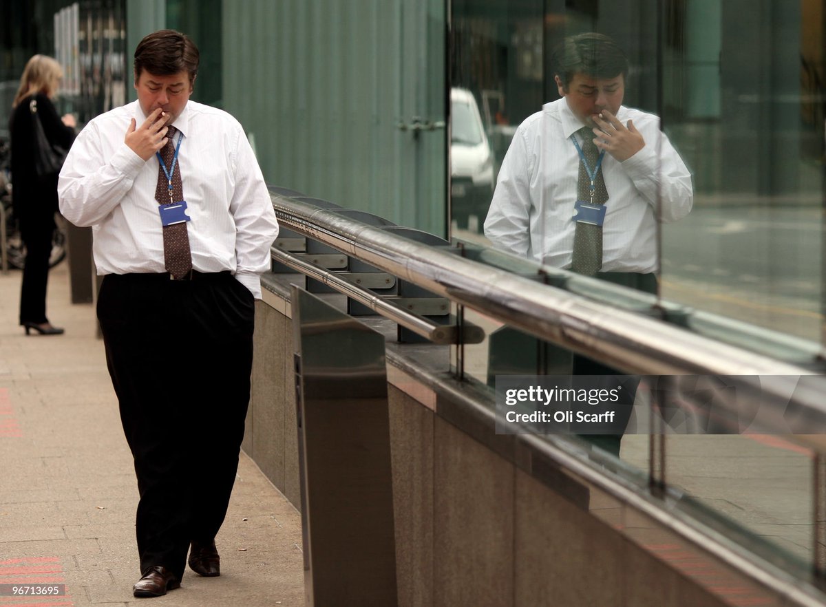 A businessman smokes a cigarette in Canary Wharf (2010)