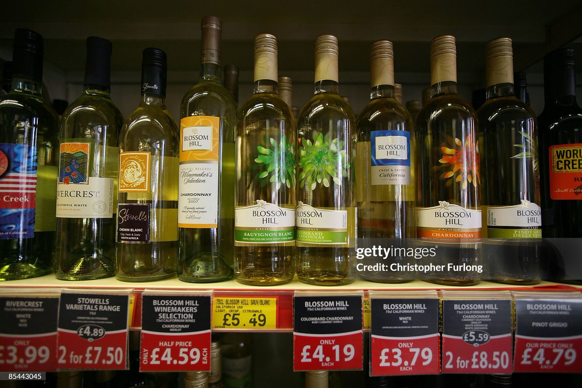 Bottles of wine line the shelves in an off licence in Knutsford, England. Sir Liam Donaldson, the Chief Medical Officer for England, has today called for a minimum price on alchohol to combat a UK drink problem (2009)