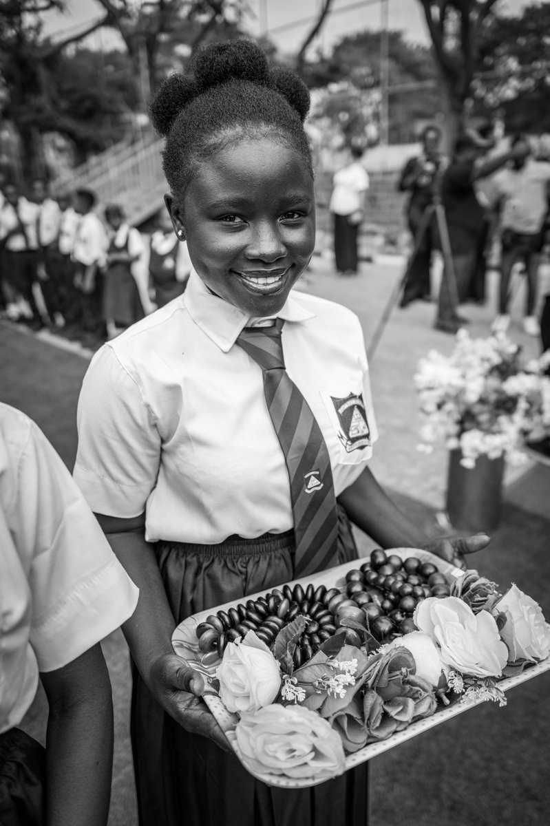 A student waiting with gifts for the arrival of the Duke and Duchess of Sussex to the Lightway Academy in Abuja, Nigeria.