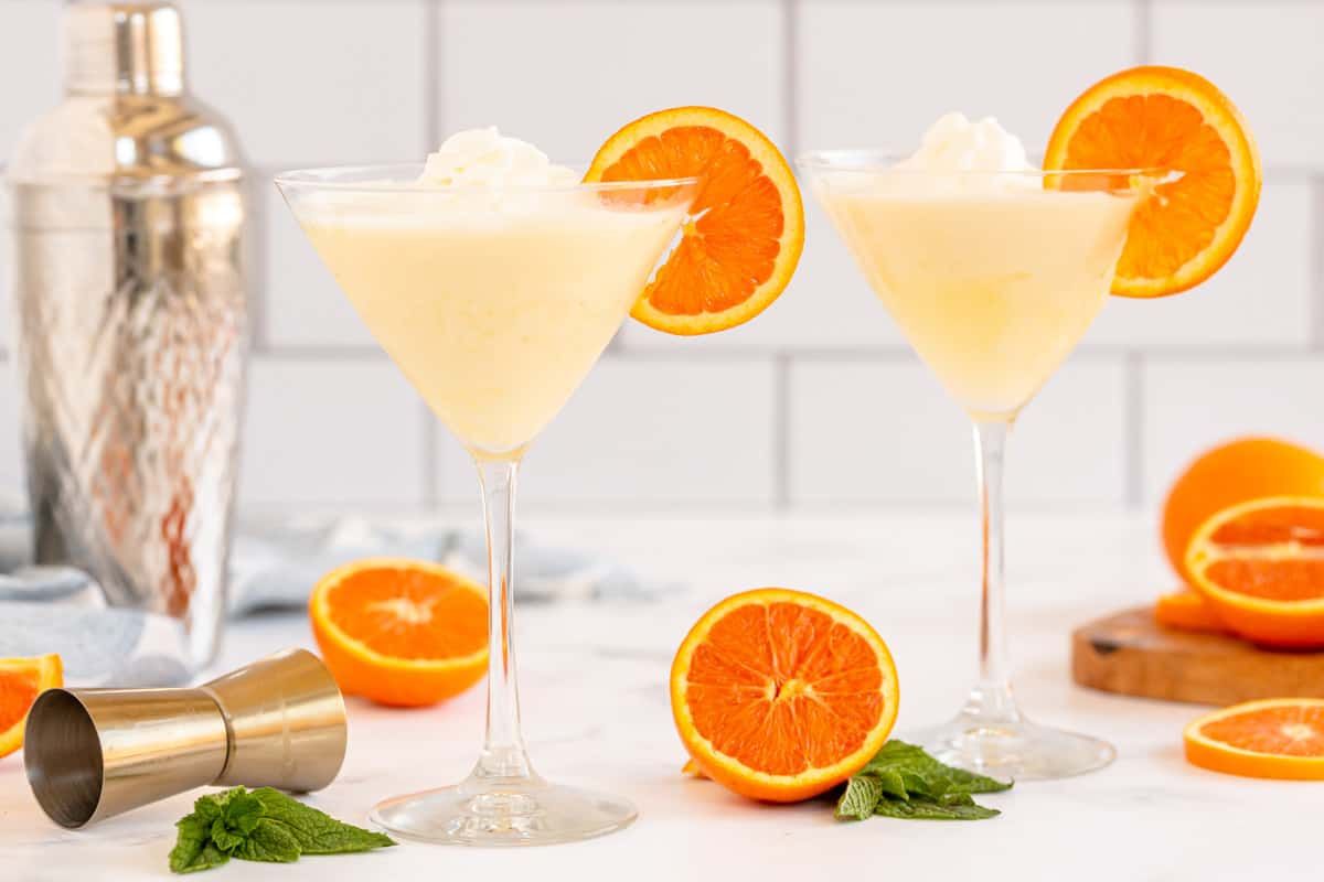 Creamy, dreamy and fruity - this orange creamsicle cocktail is fantastic! Whipped cream flavored vodka is the key ingredient in this boozy take on a classic. #cocktail #summer #orange #creamsicle #martini #kyleecooks kyleecooks.com/cocktail-orang…