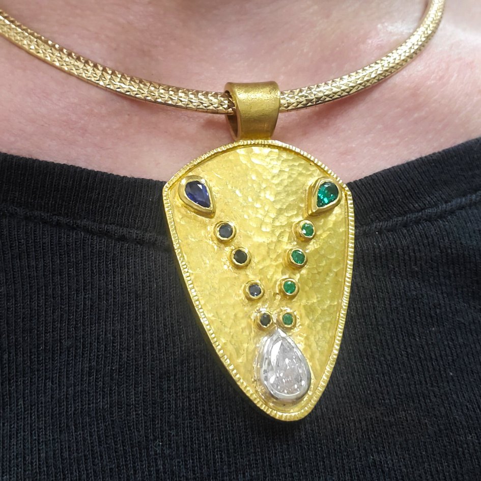 Featured: #24k #yellowgold custom family pendant shield combining lines of #sapphires and #emeralds with a #diamond, symbolizing the merging of two families. 

Crafted by Katherine Spencer and is not for sale.  Design with us: bit.ly/SnK-Bespoke-De… #morgantown #westvirginia