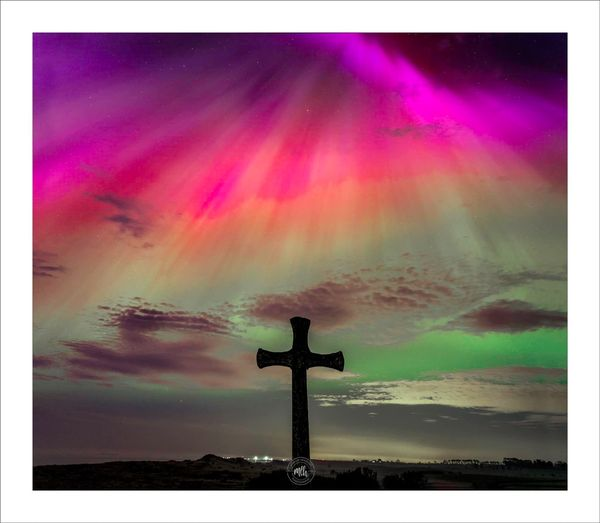 The Northern lights (aurora borealis) over St Cuthbert's Cross Alnmouth