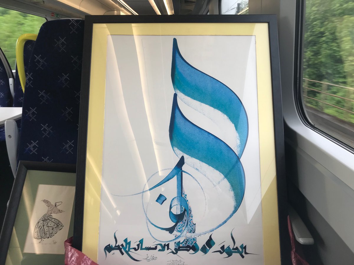 Calligraphy on the train! “The wise person’s homeland is the Universe” by @hassan_massoudy 🧡 Heading to @UofGUnescoRILA Spring School to teach about Arabic as a language of vast beauty & peace 🕊 #اللغة_العربية #فن_الخط