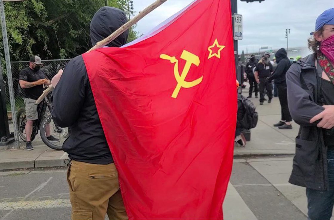 Antifa carrying a Communist flag in Portland, Oregon.