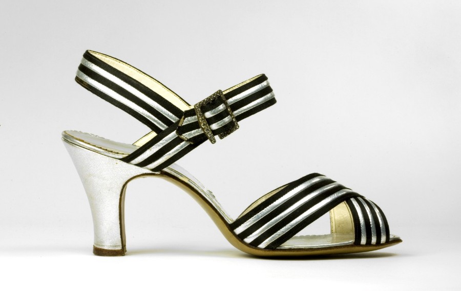 Sandals came into fashion in the 1930s and could be worn morning, noon, and night. Structurally, this evening sandal from Bally is very similar to more pedestrian sandals. However, the use of silver kid and a diamante buckle transform it into an elegant evening shoe.