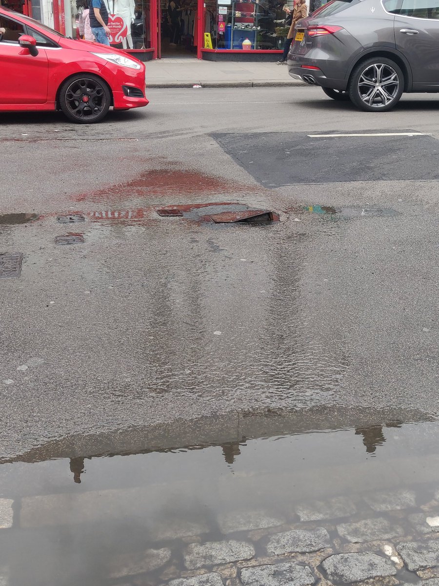 Completely destroyed manhole cover and leak on Kilburn High Road, by the junction with Willesden Lane. @thameswater please fix ASAP.