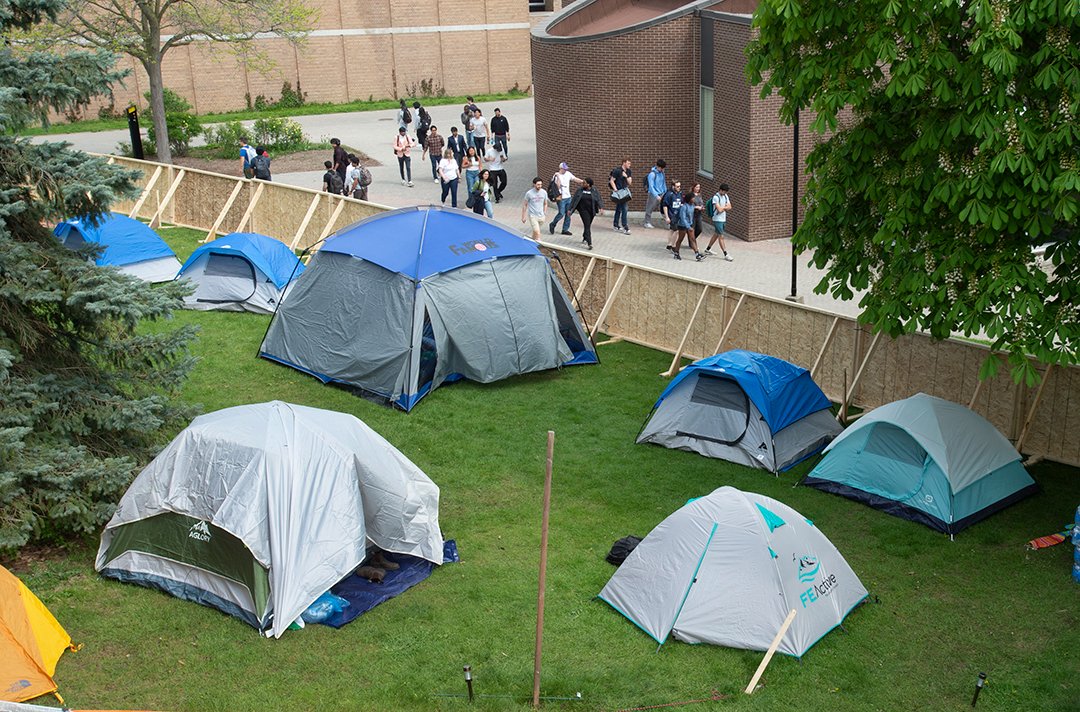 A protest encampment sits behind fencing at the Unversity of Waterloo. The protesters want the university to divest from companies that appear on the Boycott, Divestment and Sanctions list and an “academic and cultural boycott” of Israeli companies and universities.