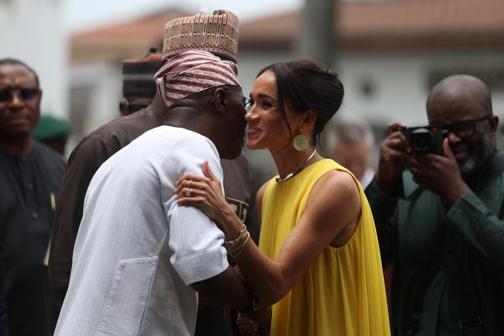 Holy smokes

Check out the grip Meghan Markle has on this man’s arm

Meghan Markle did an incredible job embarrassing Prince Harry while hugging every man she saw like a cat in heat

Nigeria is a predominantly Muslim country & married women have no business touching other men in