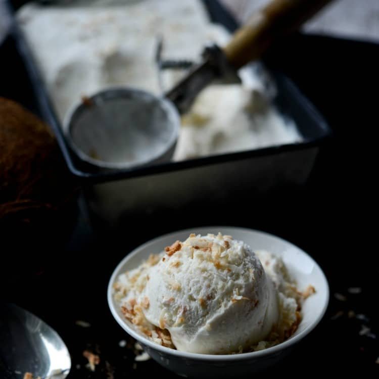 Toasted Coconut Ice Cream made with natural ingredients like coconut milk, heavy cream, sugar, coconut and vanilla extracts and flaky toasted coconut. RECIPE--> carriesexperimentalkitchen.com/toasted-coconu… #icecream #recipes