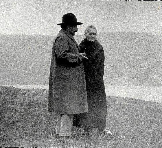 Albert Einstein and Marie Curie discussing near a lake, c. 1929.