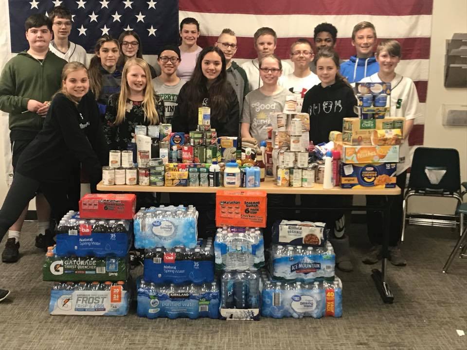 Does anyone recognize any of these little helpers pictured while displaying their donations during a food drive?  #ClassOf2024 #CommunityOutreach