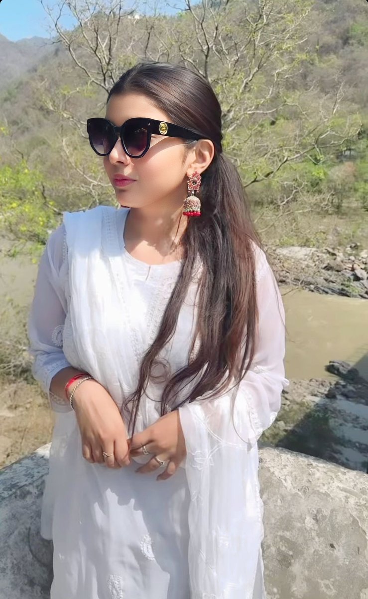 Exploring the serenity of Mussoorie in classic white attire, with a hint of mystery behind black shades. 
 #MussoorieDiaries