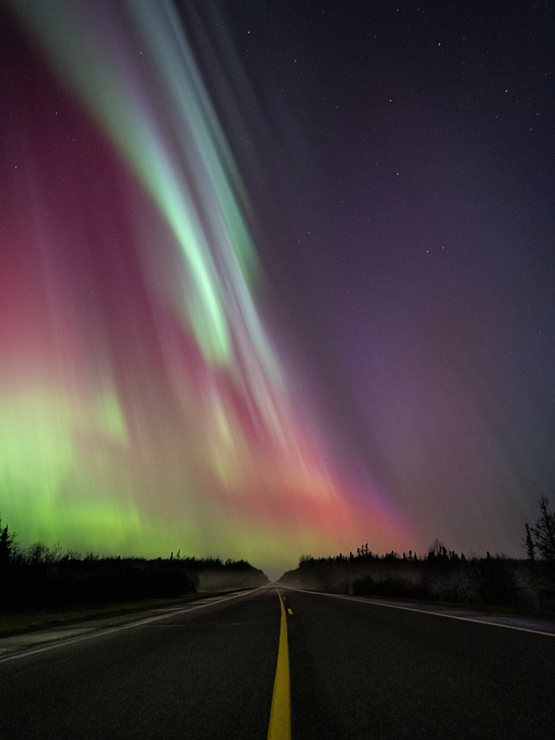 1a.m. 5/11/24. Some aurora over a lonely road in northern Minnesota.