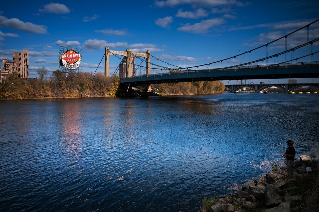 The beautiful Father Hennepin Bridge over the Mississippi River and iconic Grain Belt Beer sign. No better place to stroll along the river on a lovely spring day.