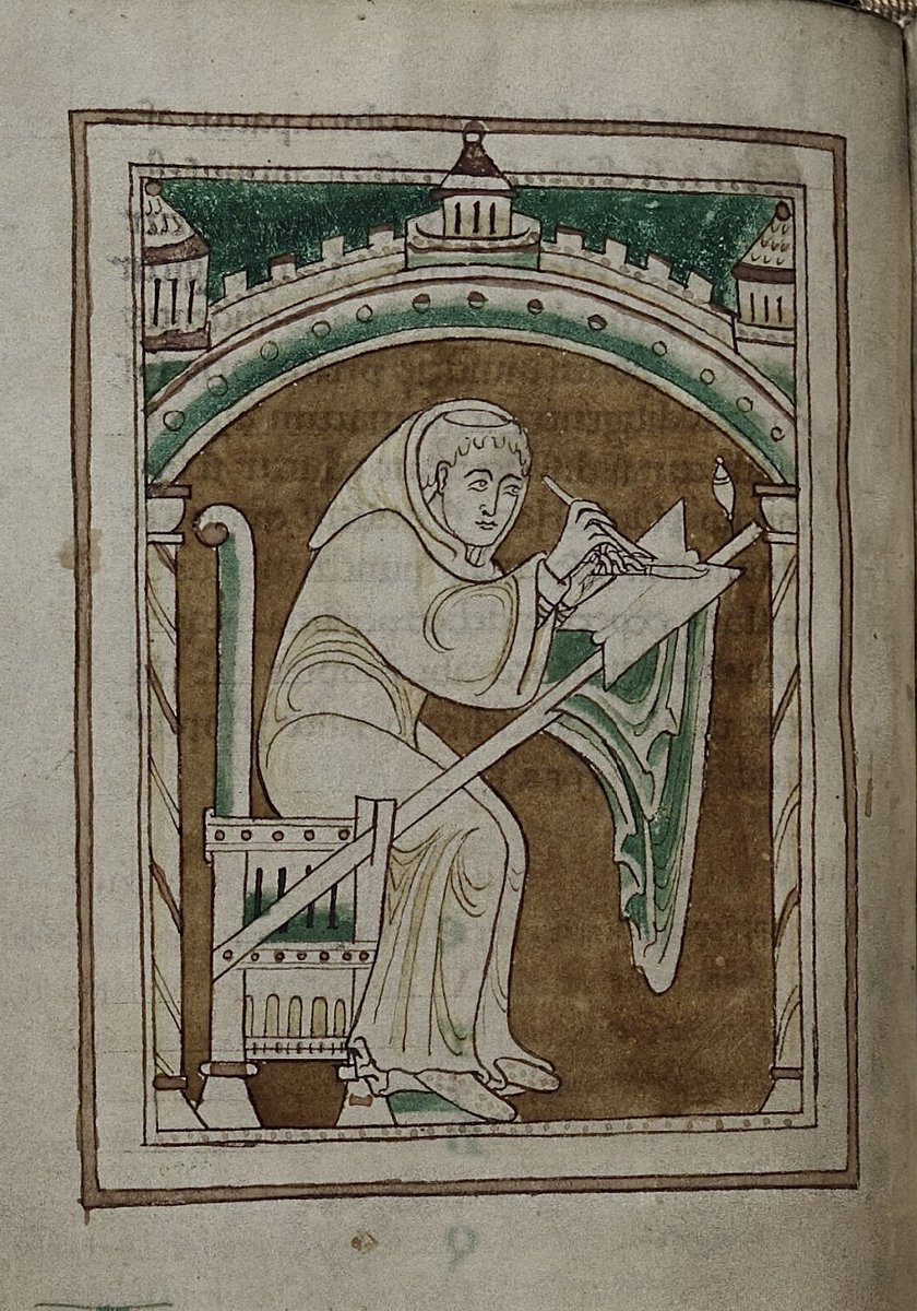 A tonsured monk (presumably Lawrence of Durham) holding quill and knife and seated on a chair Durham University Library Cosin MS. V.iii.1; Lawrence of Durham, Works; 12th century; f.22v @BedesBooks