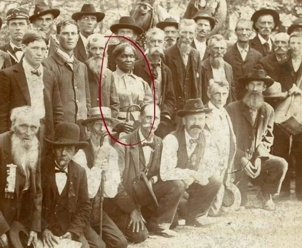 fasc1nate's tweet photo. The lady circled in red was Lucy Higgs Nichols. She was born into slavery in Tennessee, but during the Civil War she managed to escape and found her way to 23rd Indiana Infantry Regiment which was encamped nearby.  She stayed with the regiment and worked as a nurse throughout the war. 

After the war, she moved north with the regiment and settled in Indiana, where she found work with some of the veterans of the 23rd. She applied for a pension after Congress passed the Army Nurses Pension Act of 1892 which allowed Civil War nurses to draw pensions for their service.  

The War Department had no record of her, so her pension was denied. Fifty-five surviving veterans of the 23rd petitioned Congress for the pension they felt she had rightfully earned, and it was granted. 

The photograph shows Nichols and other veterans of the Indiana regiment at a reunion in 1898. She died in 1915 and is buried in a cemetery in New Albany, Indiana.