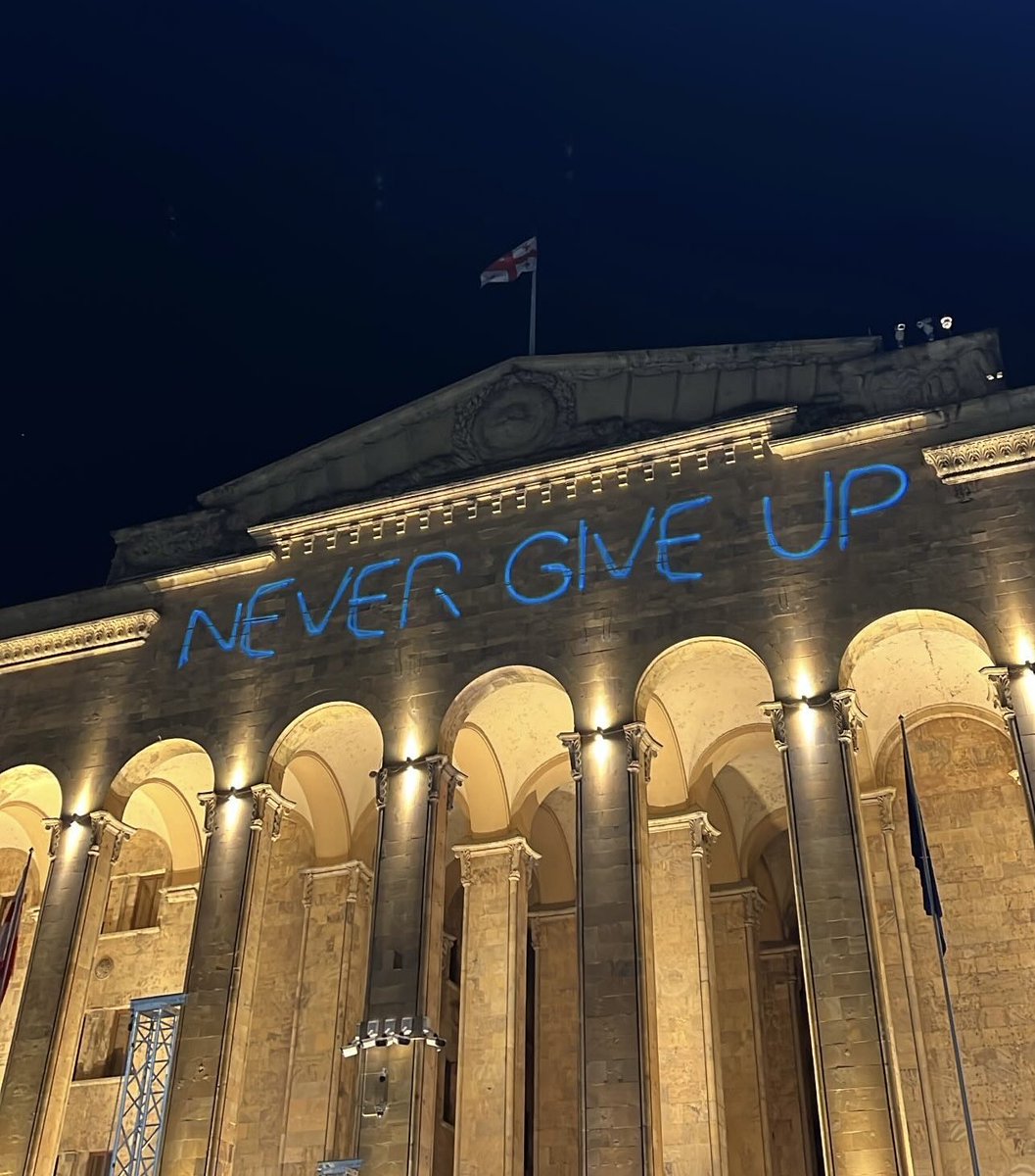 It's 23:59 in #Georgia: Laser inscription on the parliament: 'Never give up!' ✌🏻 We will never give up. We will protect our Euro-Atlantic future! Uninterrupted protests continue in several locations. All important streets are blocked. #NoToRussianLaw #TbilisiProtests #Tbilisi