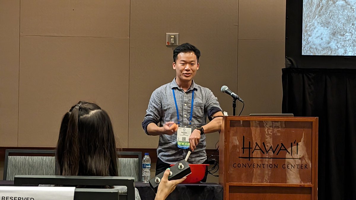 .<a href="/romainnith/">Romain Nith</a> presenting his muscle stimulation-based multi-tasking system, while himself multi-tasking to stir the bowl during the talk, being controlled by Yun, his co author, from the audience seat 💪👏😂 #CHI2024 <a href="/UChicagoCS/">UChicagoCS</a>