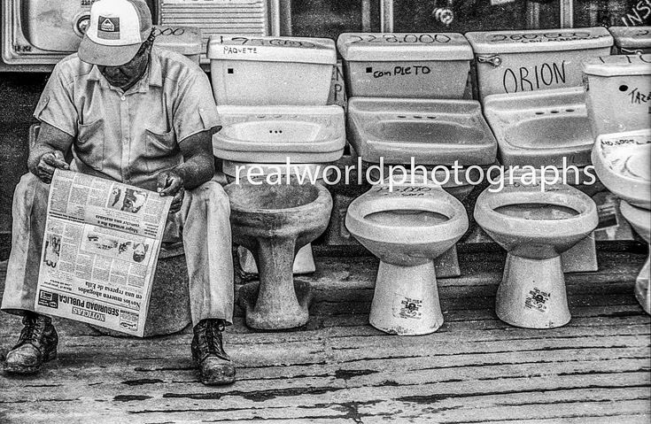 Taking a break to catch up on the news in Chihuahua, Mexico. Gary Moore photo. Real World Photographs. #malmo #sweden #chihuahua #mexico #break #toilets #nikon #film #travel #photojournalism #streetphotography #realworldphotographs #photography #documentary #garymoorephotography