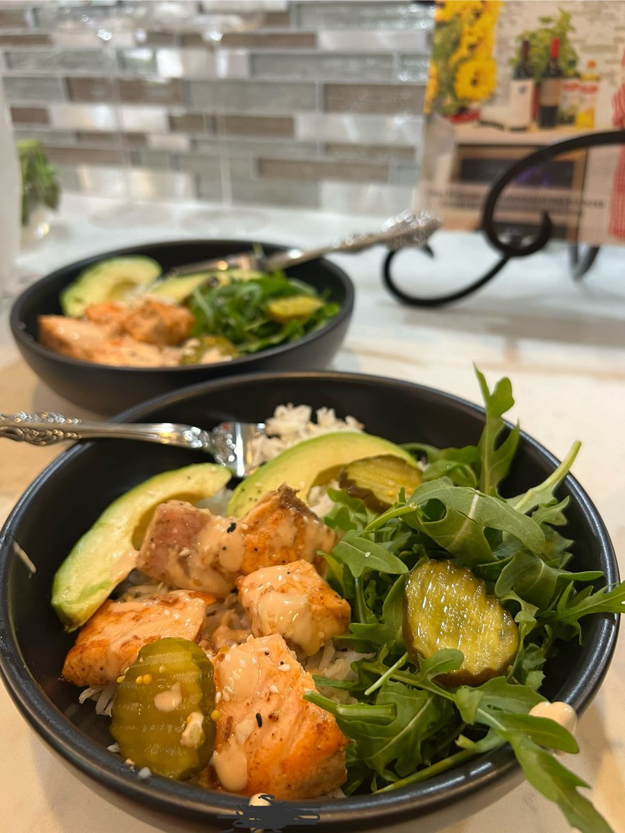 Salmon bowl with basmati rice, arugula, avocado, pickles with a garlicky lemon sauce. What are you drinking?