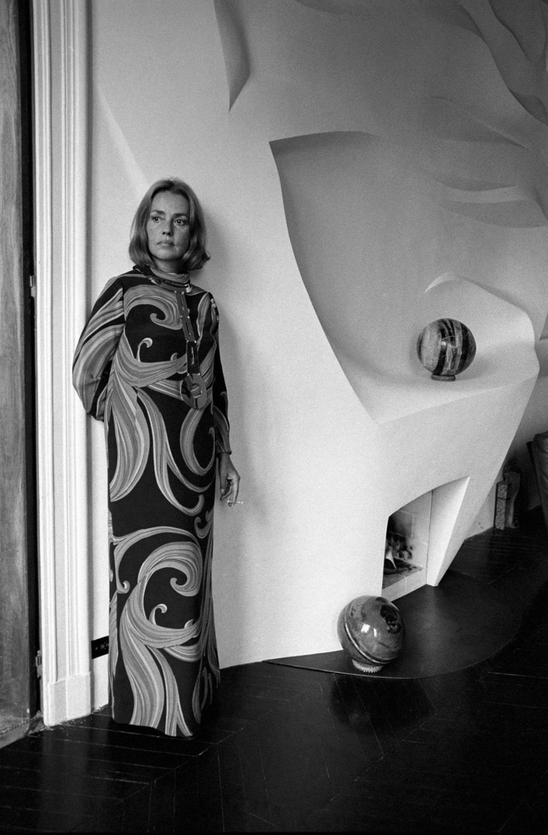 Jeanne Moreau in her Parisian apartment showcasing her new fireplace, 1970