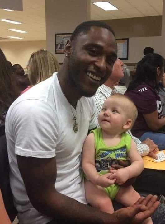 JUST BEAUTIFUL 🙏❤️ Photo of a man at the DMV holding a baby. The man does not know the child. They are strangers to each other. The parents of the child were sitting next to the man, and the baby, feeling squirmy and discontent, crawled into the man's lap. The man had just