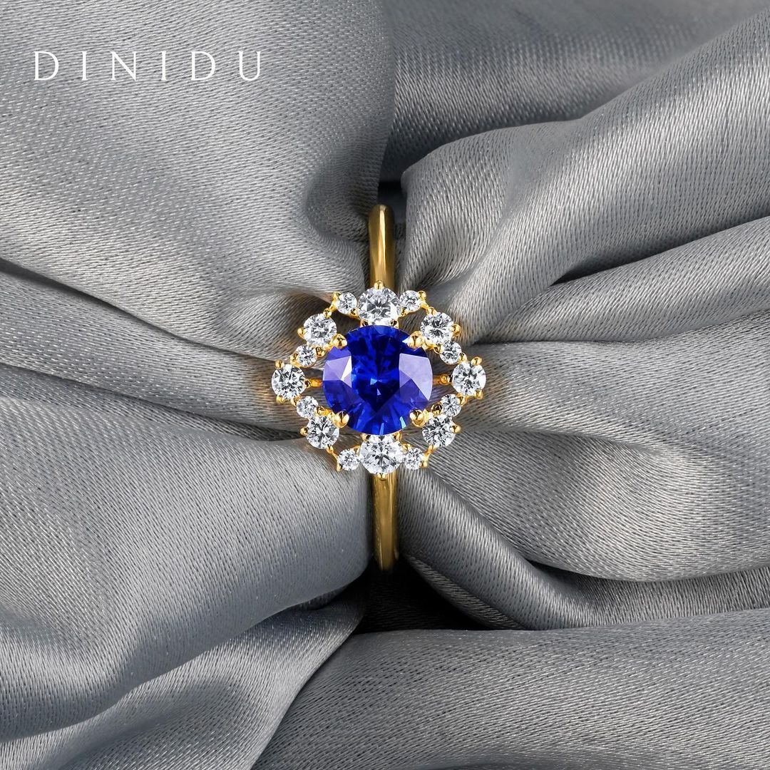 A clandestine touch, a stolen kiss or a blush that betrayed her heart echoes through the beauty of this Victorian-inspired ring. Set with a round-cut velvety blue sapphire centre stone encircled by a line of differently sized round brilliant diamonds. #DreamInDiniduJewellery