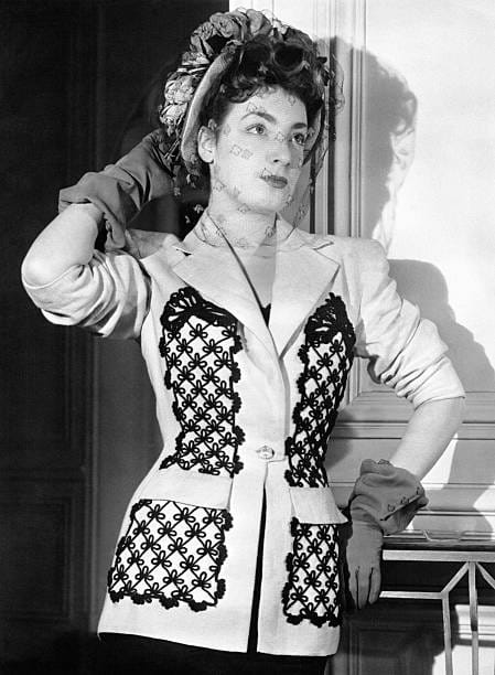 · Model in an embroidered jacket and veiled hat, Paris, 1947 Nah.