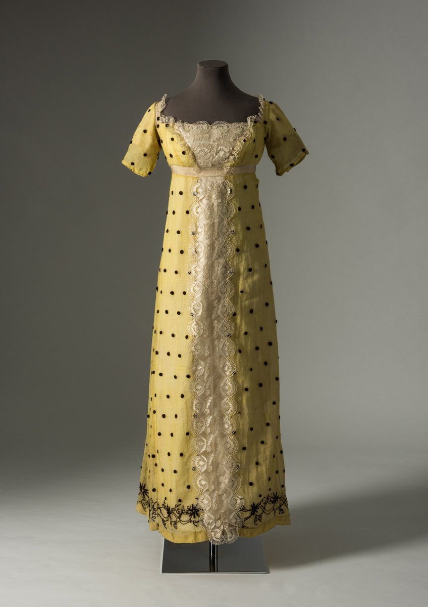 I feel that this dress has optimism, a spring in its step, mixing fabrics & colours. Pale lemon shimmers behind the black woven spot & soft silky blond lace flutters across the bodice & skirt. It has Regency flair with a bit of everything for good measure, 1815 @Fashion_Museum
