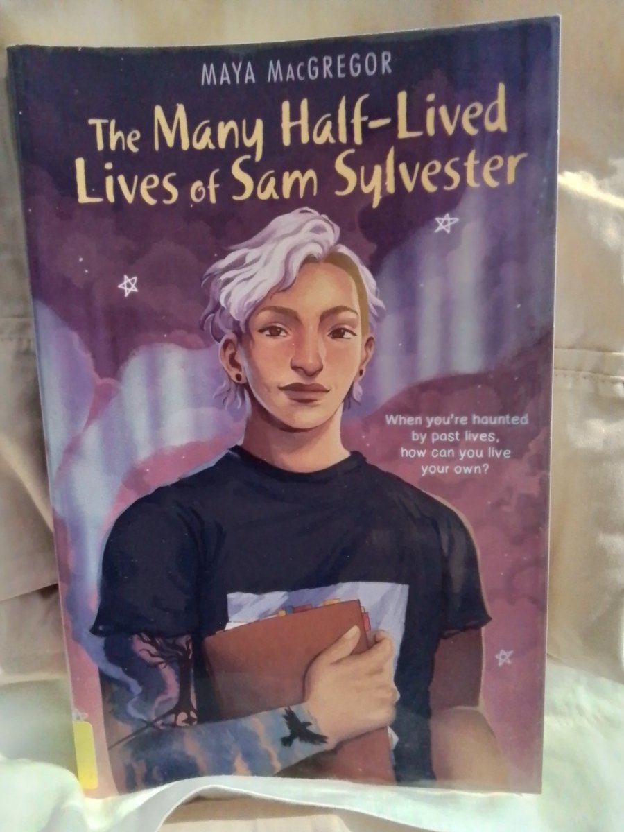 Rainy day reading. And brilliant. Queer autistic author, queer autistic main character 🏳️‍⚧️🏳️‍🌈
#ActuallyAutistic #QueerReads 
(Image: The Many Half-Lived Lives of Sam Sylvester by Maya MacGregor)