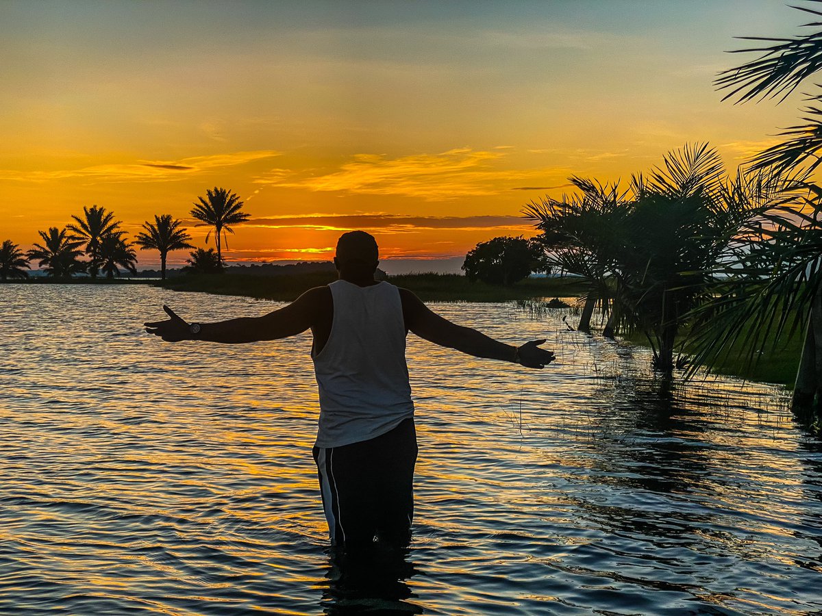 The sun sets with a reflection of beauty on an island.