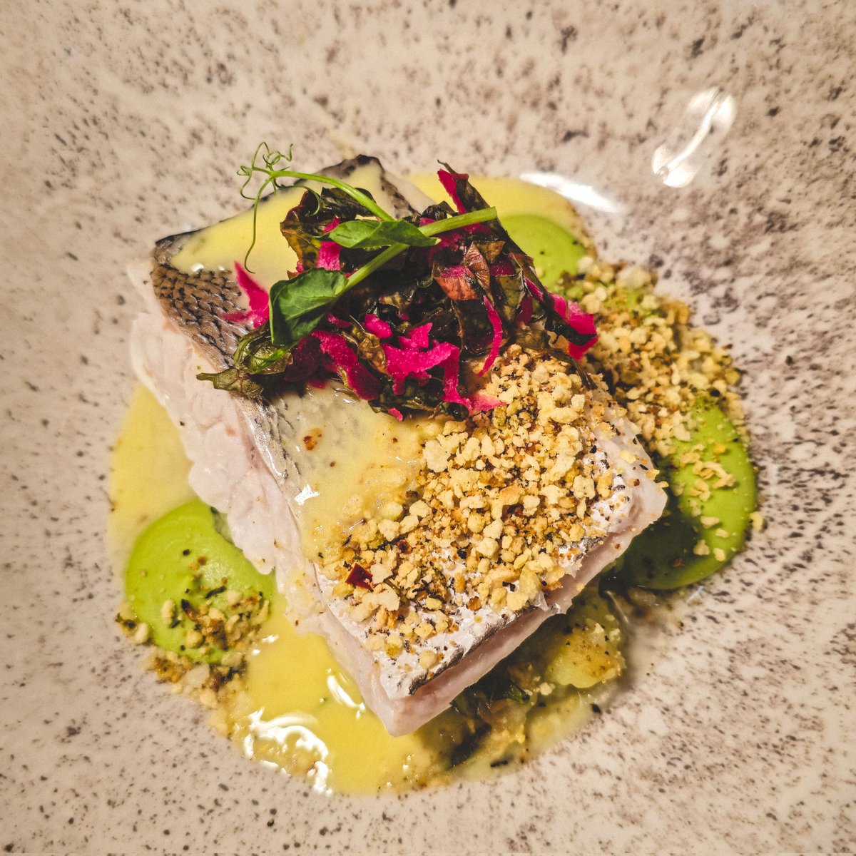 Steamed Hake with Mustard Greens, Red Spinach, Minted Pea Puree, Chimichurri Crumb, Baby Crushed Potatoes, and Wild Garlic Beurre Blanc, available on our A La Carte, Lunch, and Sunday Menus!