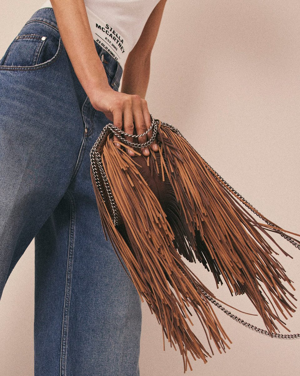 FALABELLA FOREVER: On the fringe. A Stellabration of the iconic #Falabella, rebelling against leather in luxury with a rocker attitude. Shop the Fringe Falabella Tiny Tote Bag in-store and at stellamccartney.com #FalabellaForever #StellaMcCartney #CrueltyFree #Vegan