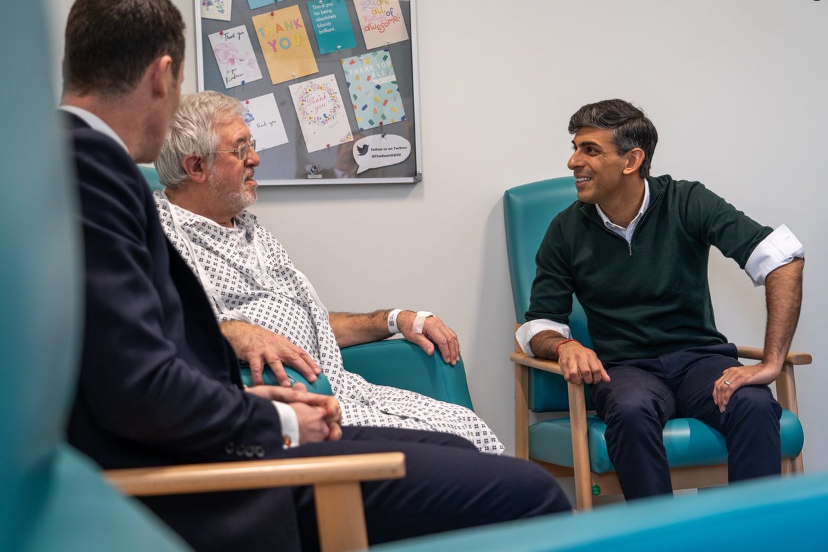 He always looks so tense when meeting the plebs. The fixed grin failing to conceal the terror. And having been advised to roll up his sleeves for that informal look, he somehow even manages to roll up his sleeves in the style of someone who has never rolled up his sleeves before.