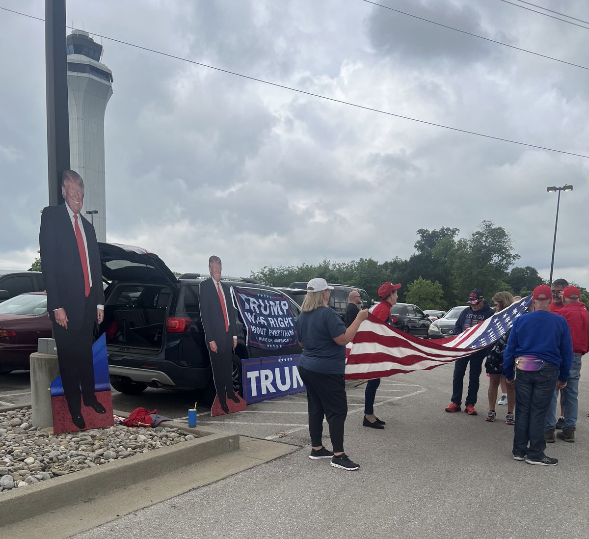 At CVG. Waiting for Trump to arrive for his Cincinnati fundraiser. Handful of supporters here in an airport parking lot…