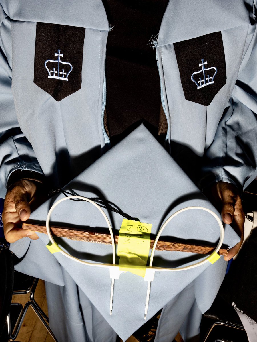 Edward Lopez shows off his graduation cap before Columbia’s graduation ceremony for the journalism school in New York, NY on 5.15.24. The cap is decorated with zip ties and a piece of the broken door of Hamiliton Hall from when NYPD forcefully removed protestors.