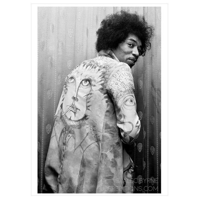 Jimi Hendrix shows off a custom jacket made for him by Mick Jagger’s brother Chris, backstage at the Saville Theatre, May 1967, Photo by Alec Byrne.