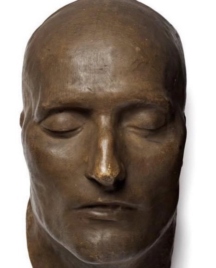 Napoleon's death mask is cast in bronze. The original cast was created 40 hours after his death in 1821.   During this era, it was customary to create a death mask for prominent leaders when they died.   

A mixture of wax or plaster was applied to Napoleon's face and removed