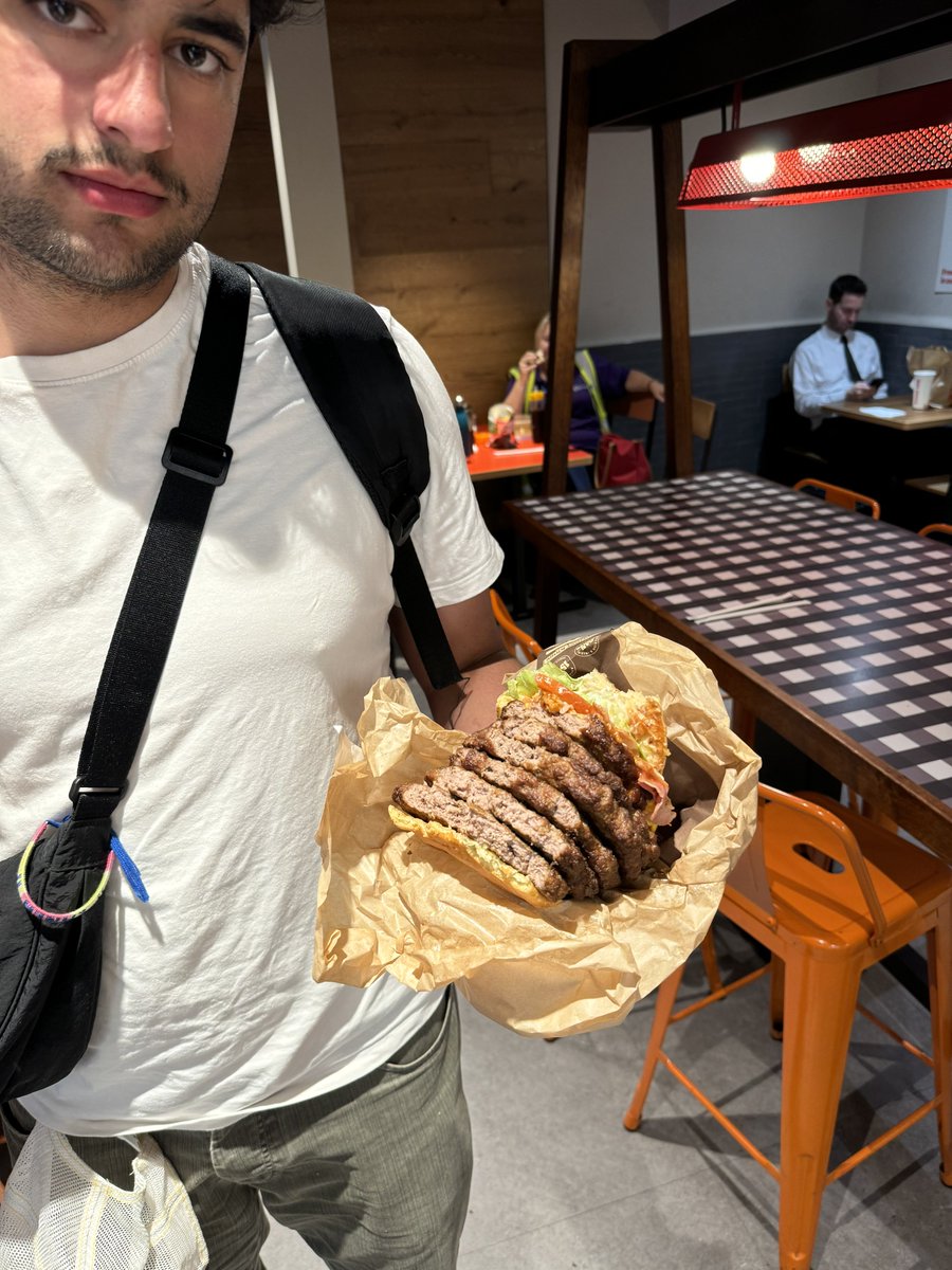 I’d vote for this guy Stansted Airport Burger King eating a whopper with six patties.