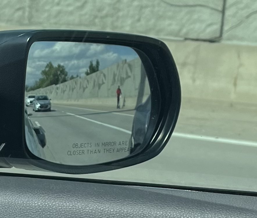 WHY IS A MAN SCOOTERING ON THE FREEWAY