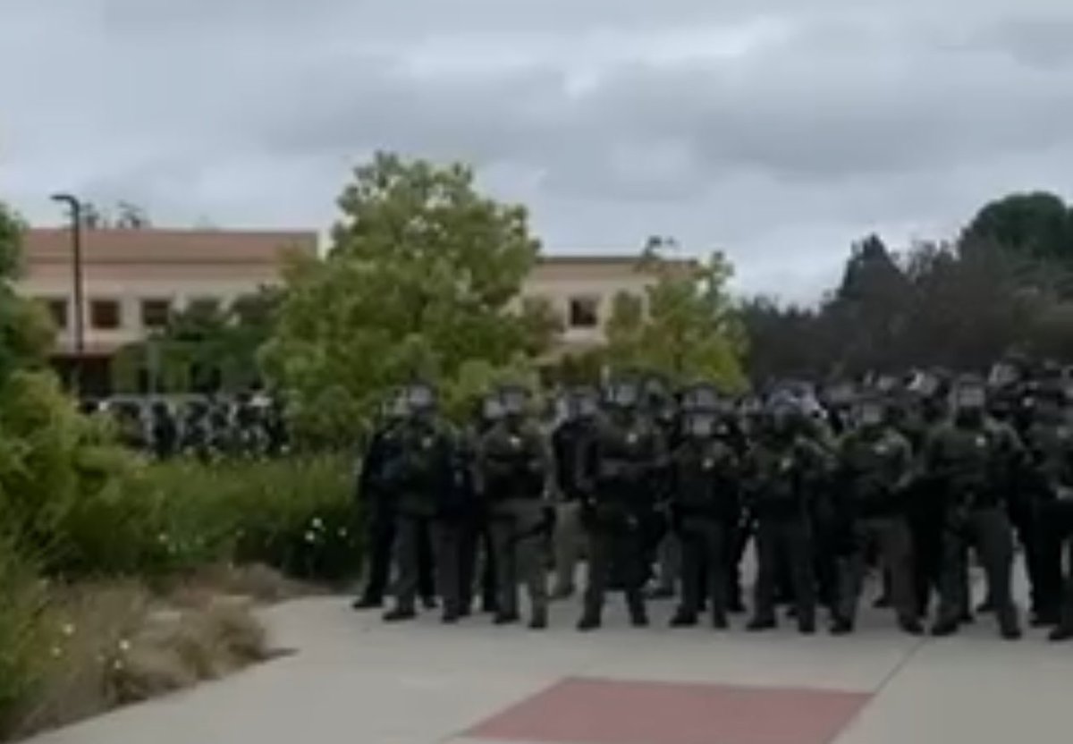 jjz1600's tweet photo. Hundreds of police in riot gear converge on campus of UC Irvine. Watching the video, I was reminded of violent police crackdowns in totalitarian states. Now it’s happening in city after city by battle ready police, trained in Israel, arresting &amp; beating students for free speech. https://t.co/EIZxde7XLj