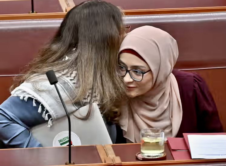 “Greens senator Mehreen Faruqi consoles Labor senator Fatima Payman” — after she was called a terrorist by an opposition member — “during question time.”